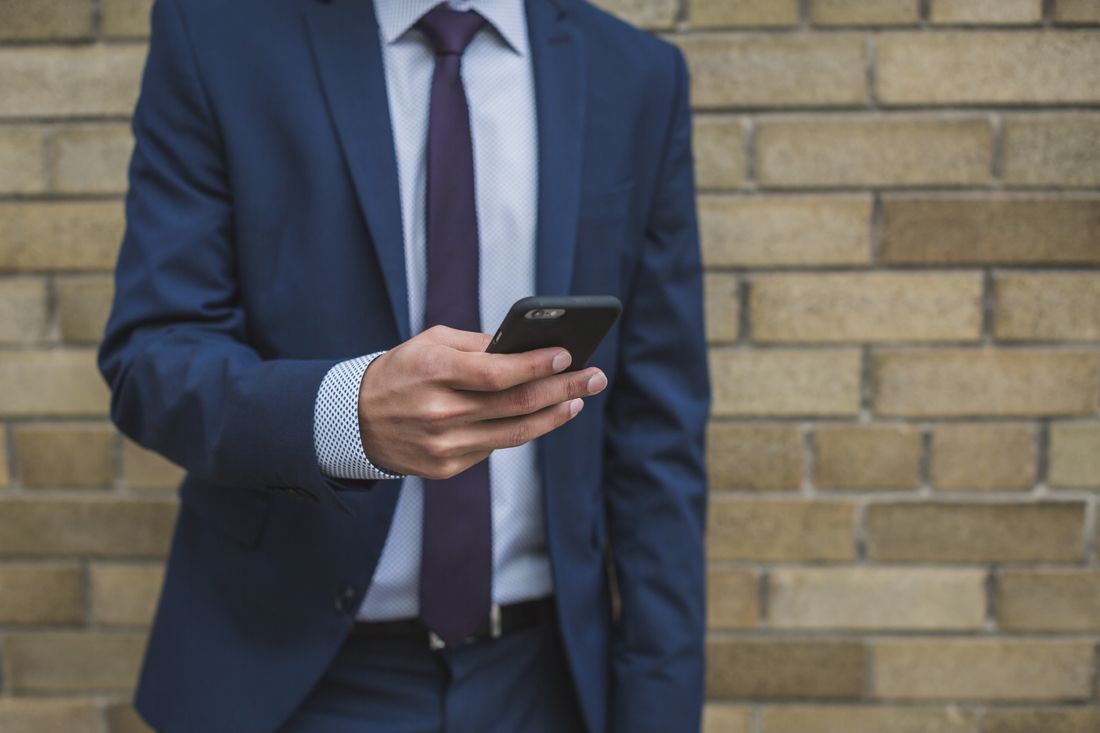 A UK business owner checking their finances on a smartphone